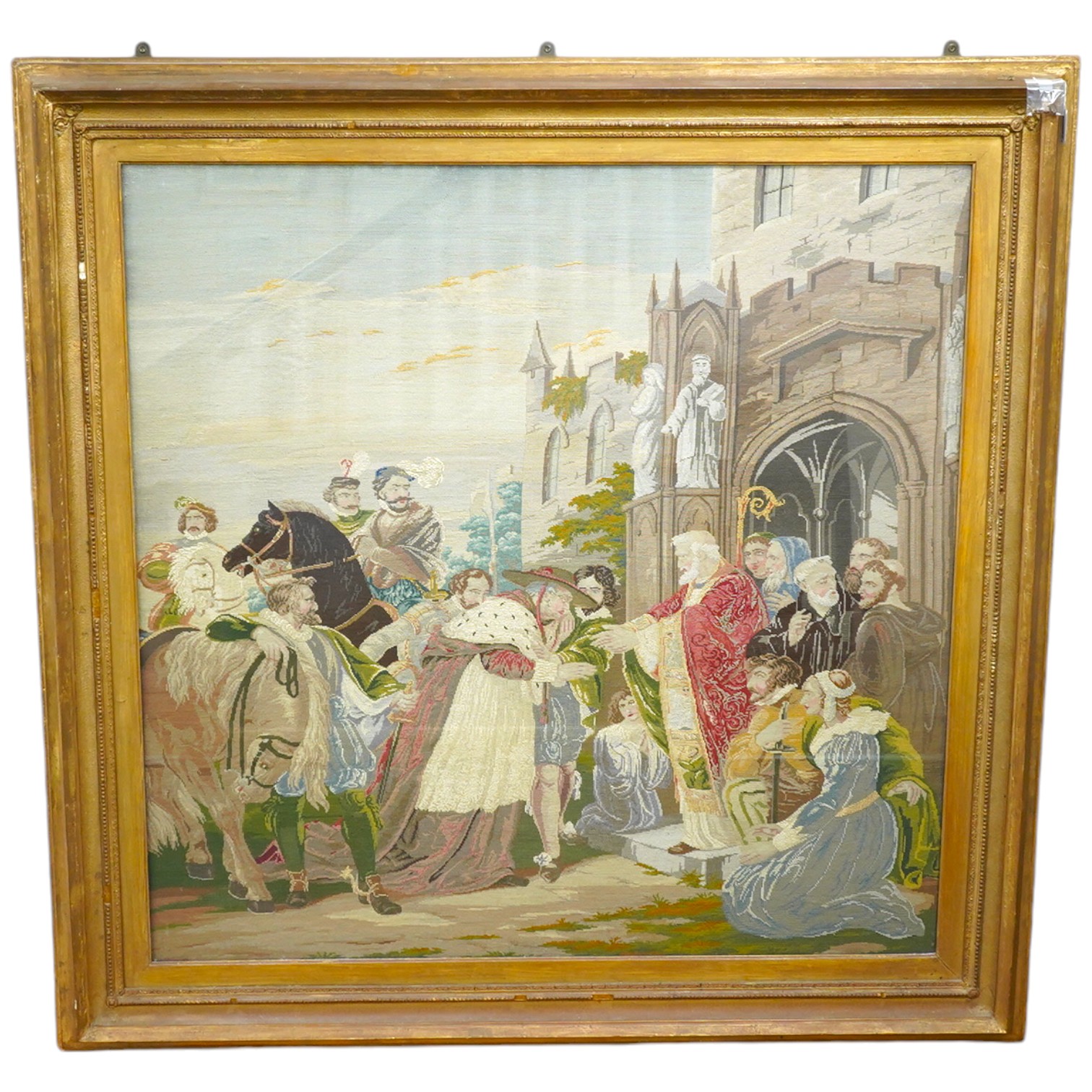 A large gilt framed English 19th century Berlin wool work, in mixed gross point and petit point, the embroidery a medieval scene of Cardinal Wolsey meeting the Archbishop of Canterbury and many courtiers and attendants o